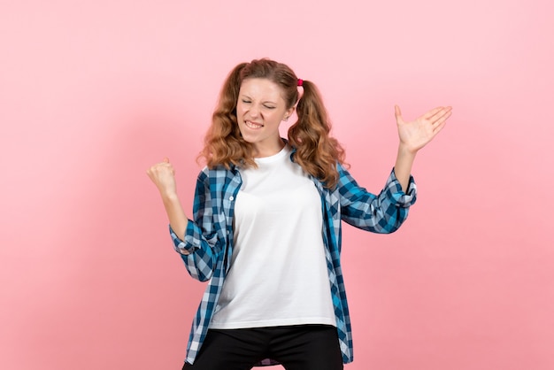 Front view young female in checkered shirt posing on light-pink background model woman emotions kid youth color