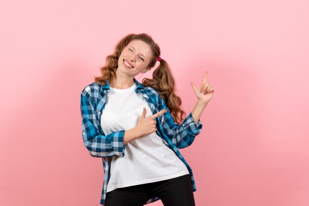 Front view young female in checkered shirt posing with smile on pink background model youth woman emotions kid color