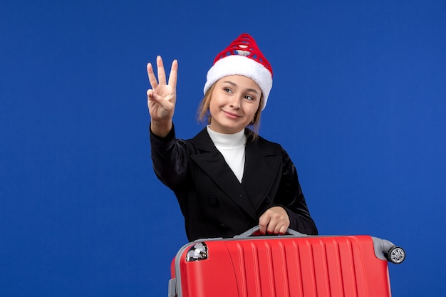 Free Photo front view young female counting showing number on blue wall holiday vacation woman