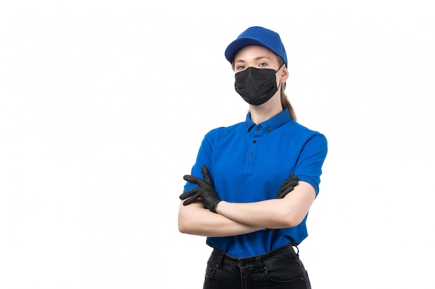 Free Photo a front view young female courier in blue uniform black gloves and black mask posing