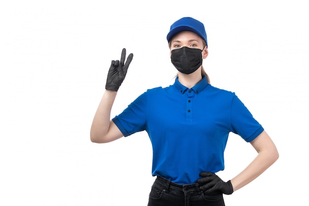 Free Photo a front view young female courier in blue uniform black gloves and black mask posing