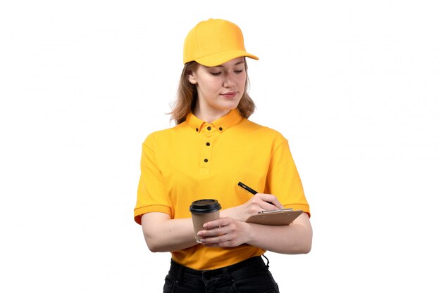 A front view young female courier female worker of food delivery service holding coffee cup and notepad on white