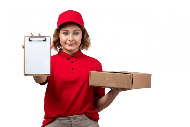 A front view young female courier female worker of food delivery service holding food package and notepad on white