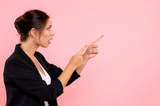 Free photo front view young female in dark jacket on a pink background