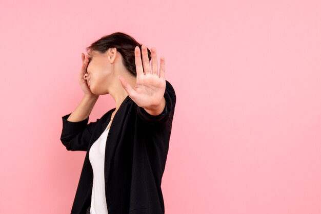 Front view young female in dark jacket on pink background