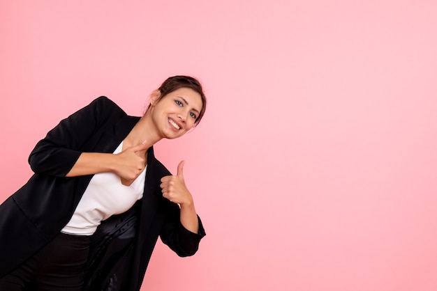 Free photo front view young female in dark jacket on pink background