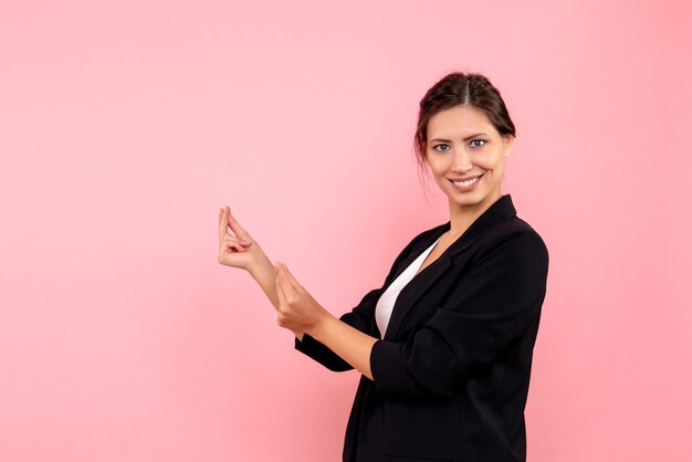 Front view young female in dark jacket on pink background