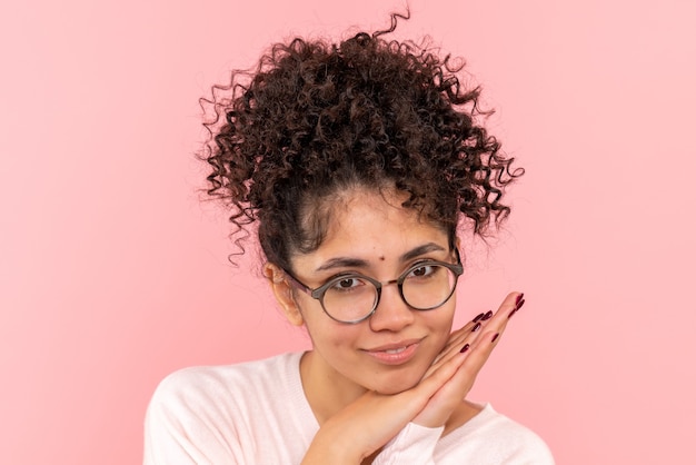 Front view of young female delighted on pink