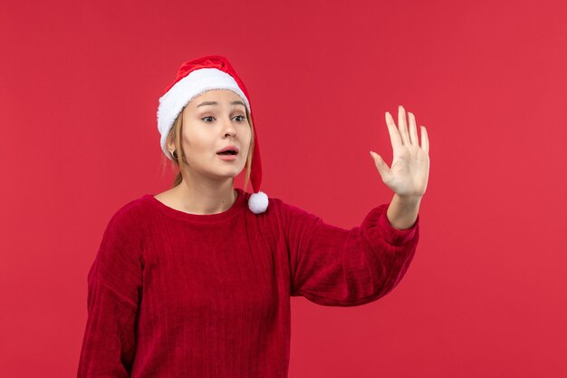 Front view young female greeting someone, holiday red christmas