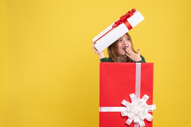 Free Photo front view young female hiding inside present box