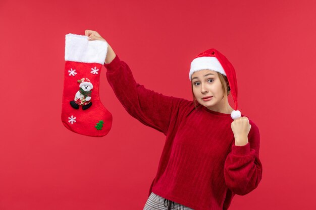 Free Photo front view young female holding christmas sock, red christmas holiday