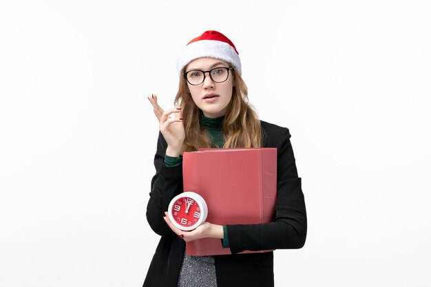 Front view young female holding clock and files on a white wall books lesson college