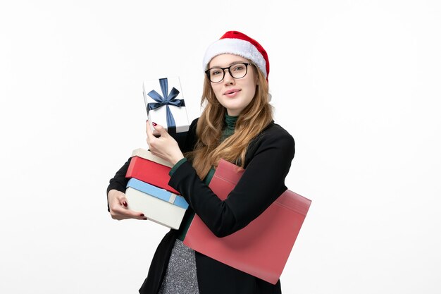 Front view young female holding holiday presents on white wall gift books new year