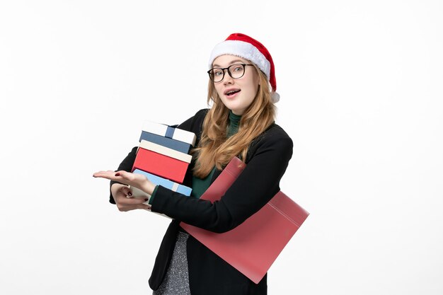 Front view young female holding holiday presents on white wall new year gift christmas