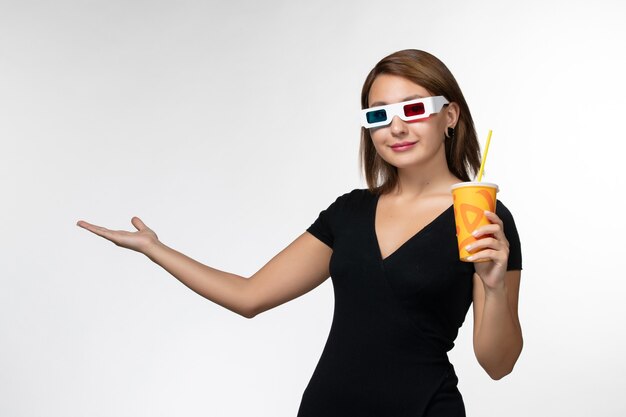 Front view young female holding soda in d sunglasses on a white surface