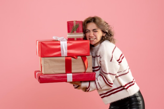 Front view young female holding xmas presents