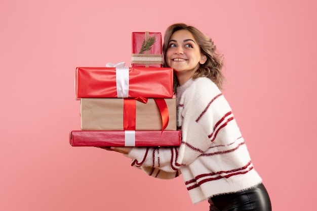 Front view young female holding xmas presents