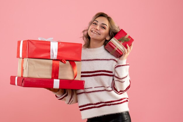 Front view young female holding xmas presents