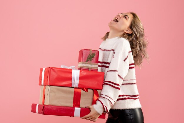 Front view young female holding xmas presents