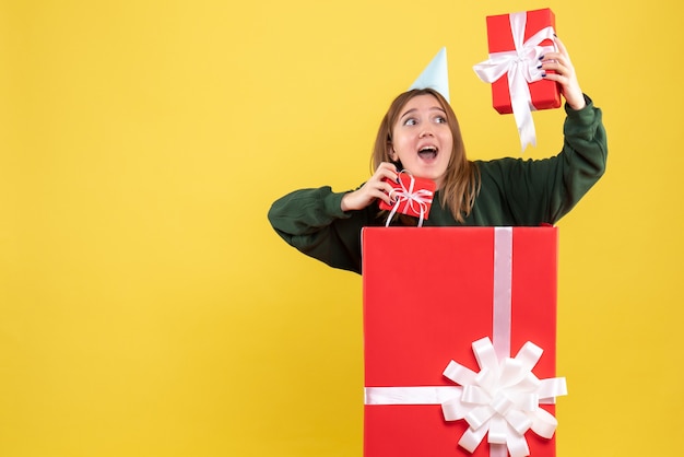 Front view young female inside present with gifts