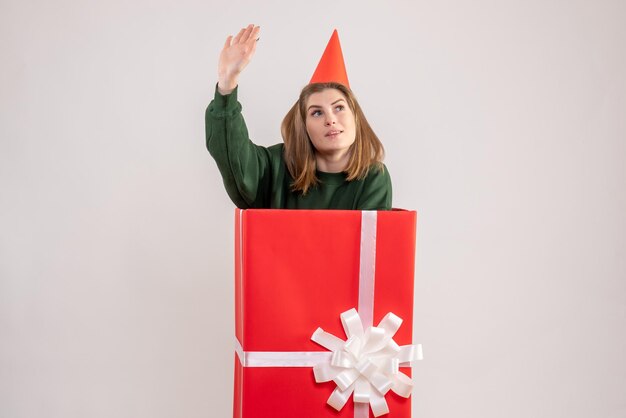 Front view young female inside red present box