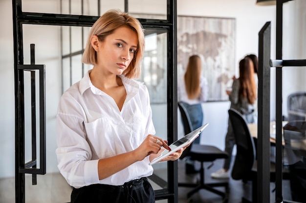 Front view young female at office working on tablet