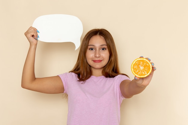 Free photo front view young female in pink t-shirt and blue jeans holding orange and white