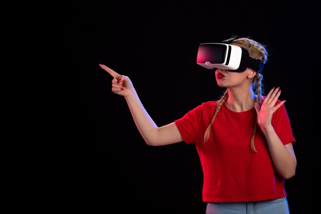 Front view of young female playing vr on dark  game tech ultrasound visual