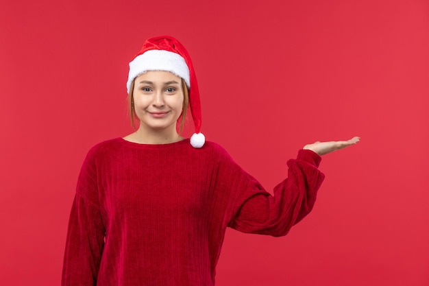 Front view young female in red cap and christmas mood, red christmas eve