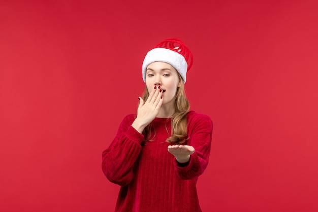 Front view young female in red cap with surprised face, holiday red woman