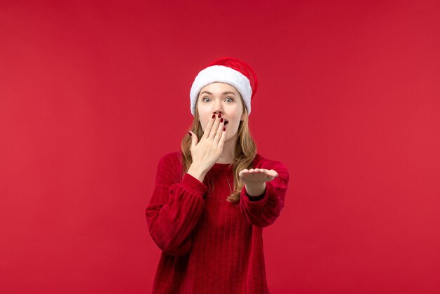 Front view young female in red cap with surprised face, holidays red woman