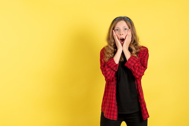 Front view young female in red checkered shirt posing on yellow background model girls woman emotions human female color