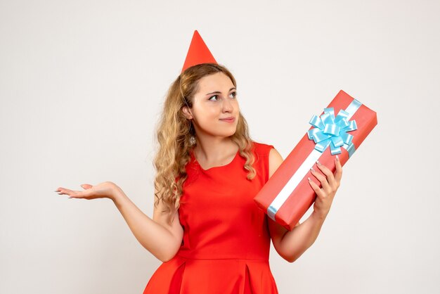 Front view young female in red dress celebrating christmas with present