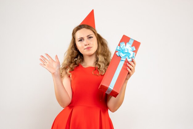 Front view young female in red dress celebrating christmas with present