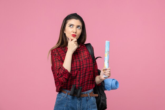 Front view young female in red shirt with map on light-pink background color fashion woman