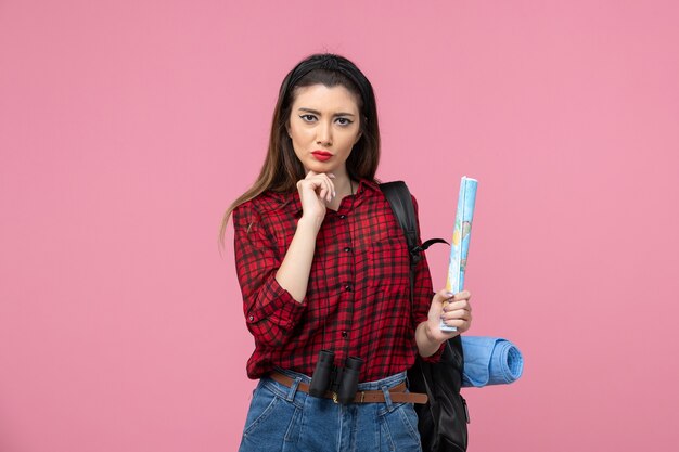 Front view young female in red shirt with map on a pink background color woman fashion