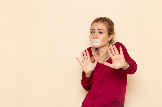 Free Photo front view young female in red shirt with tied mouth on the light space female cloth  photo