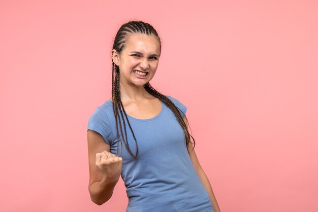 Front view of young female rejoicing on pink