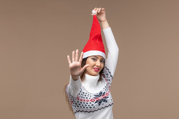 Front view young female showing number on brown background holiday christmas emotion