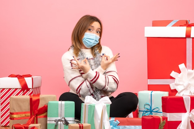 Free Photo front view young female sitting around presents