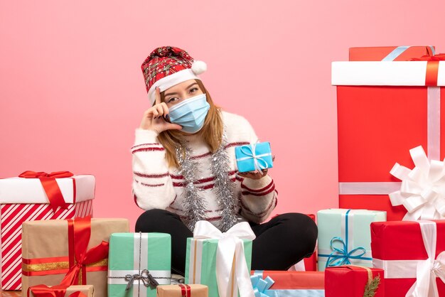 Front view young female sitting around presents