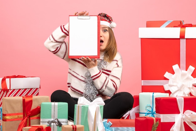 Free Photo front view young female sitting around xmas presents