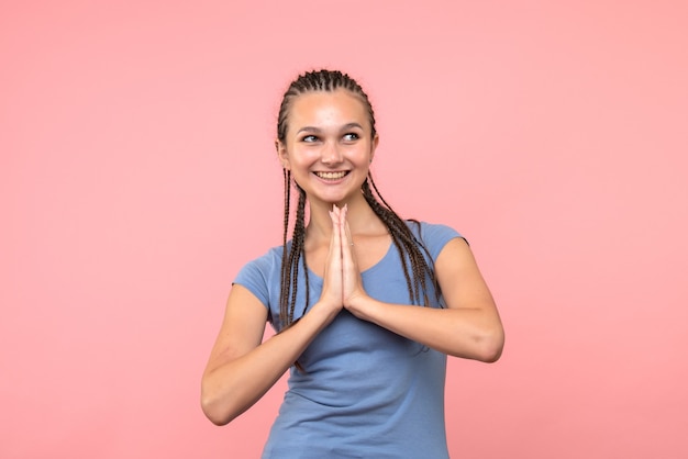 Free photo front view of young female smiling on pink