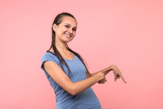 Front view of young female smiling on pink