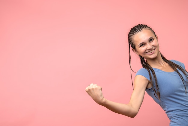 Front view of young female smiling on pink