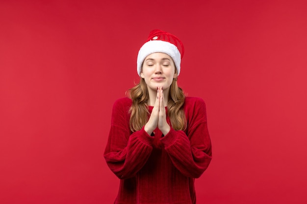 Free Photo front view young female smiling and praying, christmas holidays