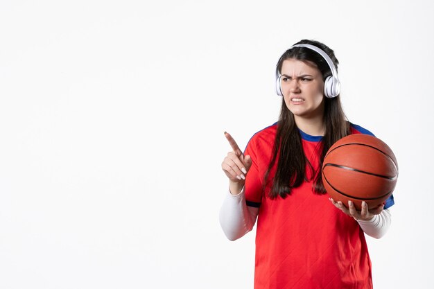 Front view young female in sport clothes with basketball