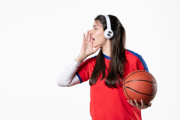 Front view young female in sport clothes with basketball