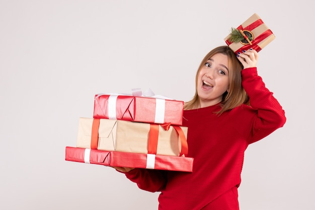 Front view young female standing with presents in her hands