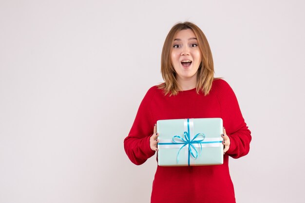 Front view young female standing with xmas present